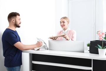 Female receptionist receiving parcel at workplace
