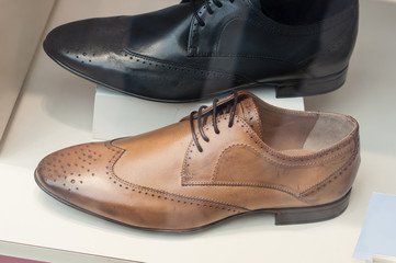 closeup of classic leather shoes for men in fashion store showroom