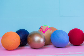 Creative Easter layout made of colorful eggs and  on blue background.