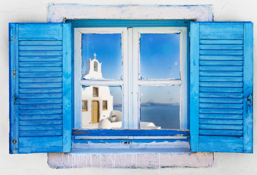 Beautiful vintage Greek window with blue shutters. Typical Greek picture.