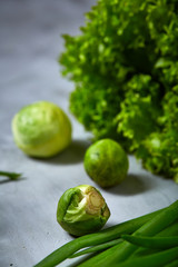 Fresh vegetables still life over white textured background, close-up, flat lay.