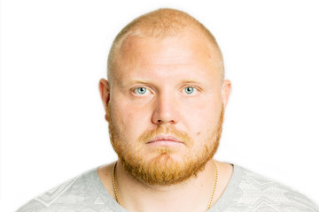 Cute man with beard and serious face, close-up, isolated