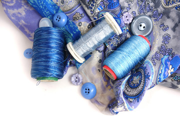 Multicolored accessories for sewing, bright threads, buttons and cloth