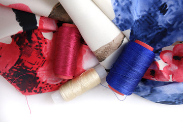 Multicolored accessories for sewing, bright threads, buttons and cloth