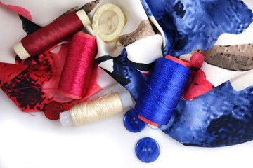 Multicolored accessories for sewing, bright threads, buttons and cloth