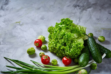 Fresh vegetables still life over white textured background, close-up, flat lay.