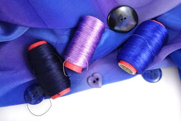 Multicolored accessories for sewing, bright threads, buttons and cloth