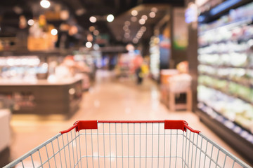 shopping cart with Abstract supermarket grocery store blurred defocused background with bokeh light