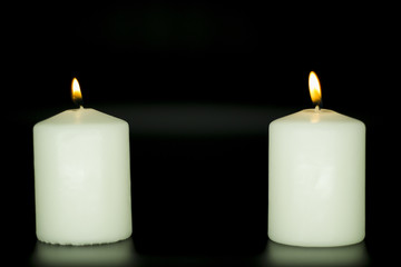 Candle on isolated black background.