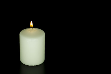 Fototapeta na wymiar Candle on isolated black background.