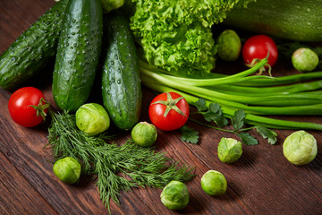 Fresh vegetables composition over wooden background, close-up, flat lay.