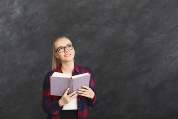 Young smiling woman with book