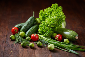Fresh vegetables composition over wooden background, close-up, flat lay.