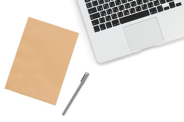 Isolated Kraft paper sheet on a white background next to a laptop with black Russian and English keyboard and gray handle, horizontal flat-lay