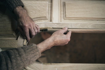 Close up shot of old master carpenter working in his woodwork or workshop