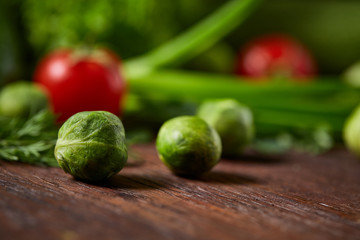 Fresh vegetables composition over wooden background, close-up, flat lay.