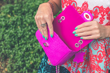 Woman hands with luxury handmade snakeskin leather handbag. Python snake fashionable handbag. Outdoors, Bali island.