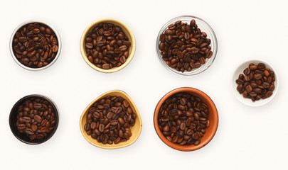 Roasted coffee beans in bowls, top view, white isolated background