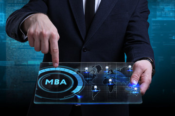 Business, Technology, Internet and network concept. Young businessman working on a virtual screen of the future and sees the inscription: MBA