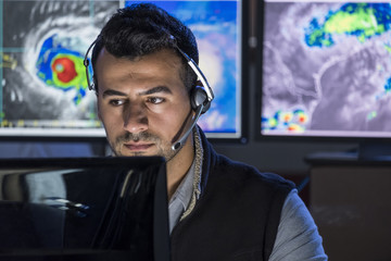 Meteorologist monitoring storms on his computer screen, close up shot