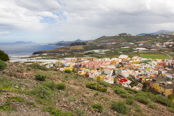 Fototapeta na wymiar Scenic top views of Santa Maria de Guia town from Atalayita mountain in Gran Canaria on cloudy day. Panorama of Canary Islands