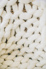 Closeup of white handmade knitted blanket.