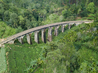 Fototapeta premium Old railway in the jungle. Aerial View. Nine Arches Bridge is located in Demodara, Ella city, Sri Lanka.