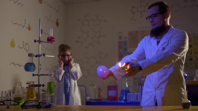 Scientists makes experiment with fire and balloon in laboratory