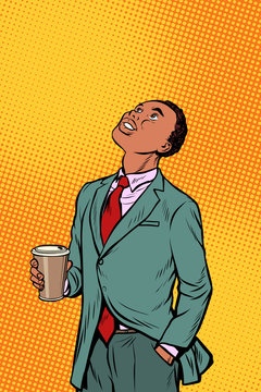 African businessman drinking coffee and looking up