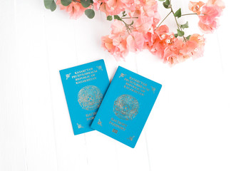 Kazakhstan passport, pink bougainvillea on a white background. top view