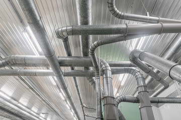 Industrial metal pipes along the ceiling, ventilation system
