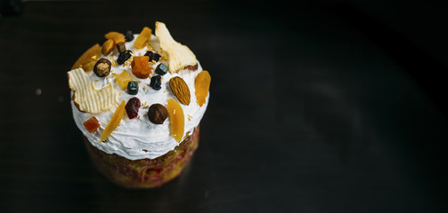 easter cake with dried fruits and nuts on black background horizontal