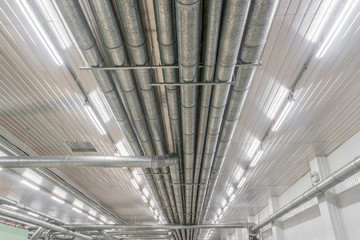 Industrial metal pipes along the ceiling, ventilation system