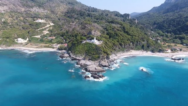 Chapel on the Cape. Aerial view of a white chapel on an exotic cape