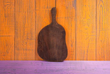 Cutting Board on wooden orange purple background horizontal