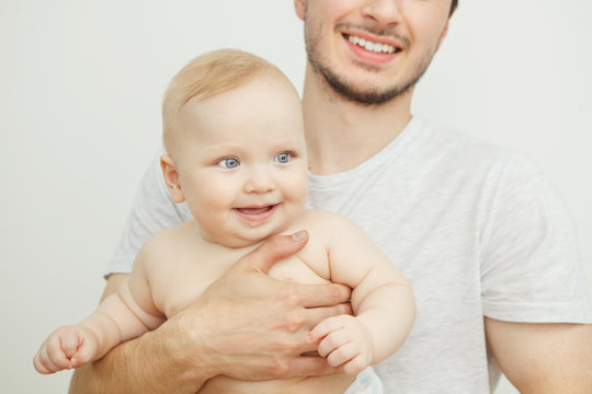 Smiling happy baby in father's hand. Little enfant toddler