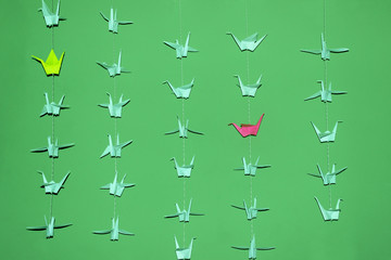 A Lot Of Origami Birds On The Wall. Origami Birds Over Green Background. Abstract Colored Background.Paper Cranes.

