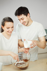 Man and woman preparing sweet dessert together. Happy couple