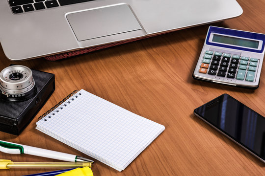 photo desktop with office supplies calculator phone notebook