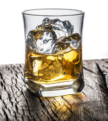 Whiskey glass or glass of whiskey with ice cubes on the table at white background.