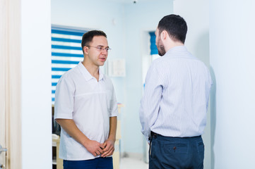 Doctor talking to a patient in a hallway
