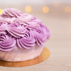 birthday concept - close up of purple cake over wooden background