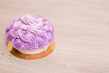 birthday concept - purple cake and copy space on wooden table