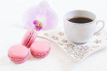 Pink macaroon and cup of coffee