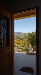 View of mountain and field from doorway, Crete, Greece