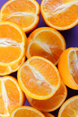 Fruit oranges on a purple background, a lot of orange halves for vegan, sliced citrus fruits for breakfast, fruit pop art pattern, vitamin set designer, juicy orange fruit, art