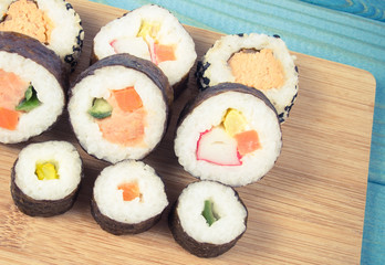 Various kinds of sushi on the blue background.