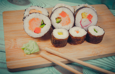 Various kinds of sushi on the blue background.