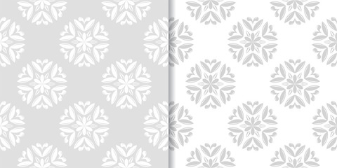 Light gray floral ornamental designs. Set of seamless patterns