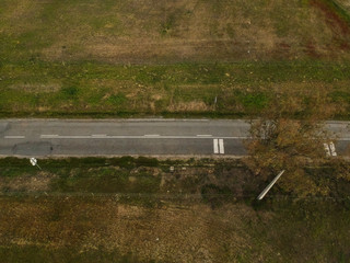 Fototapeta premium aerial view of village road and harvest fields